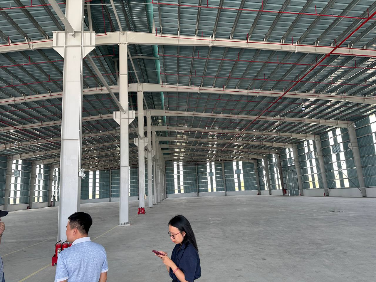 a man and woman standing in a large building