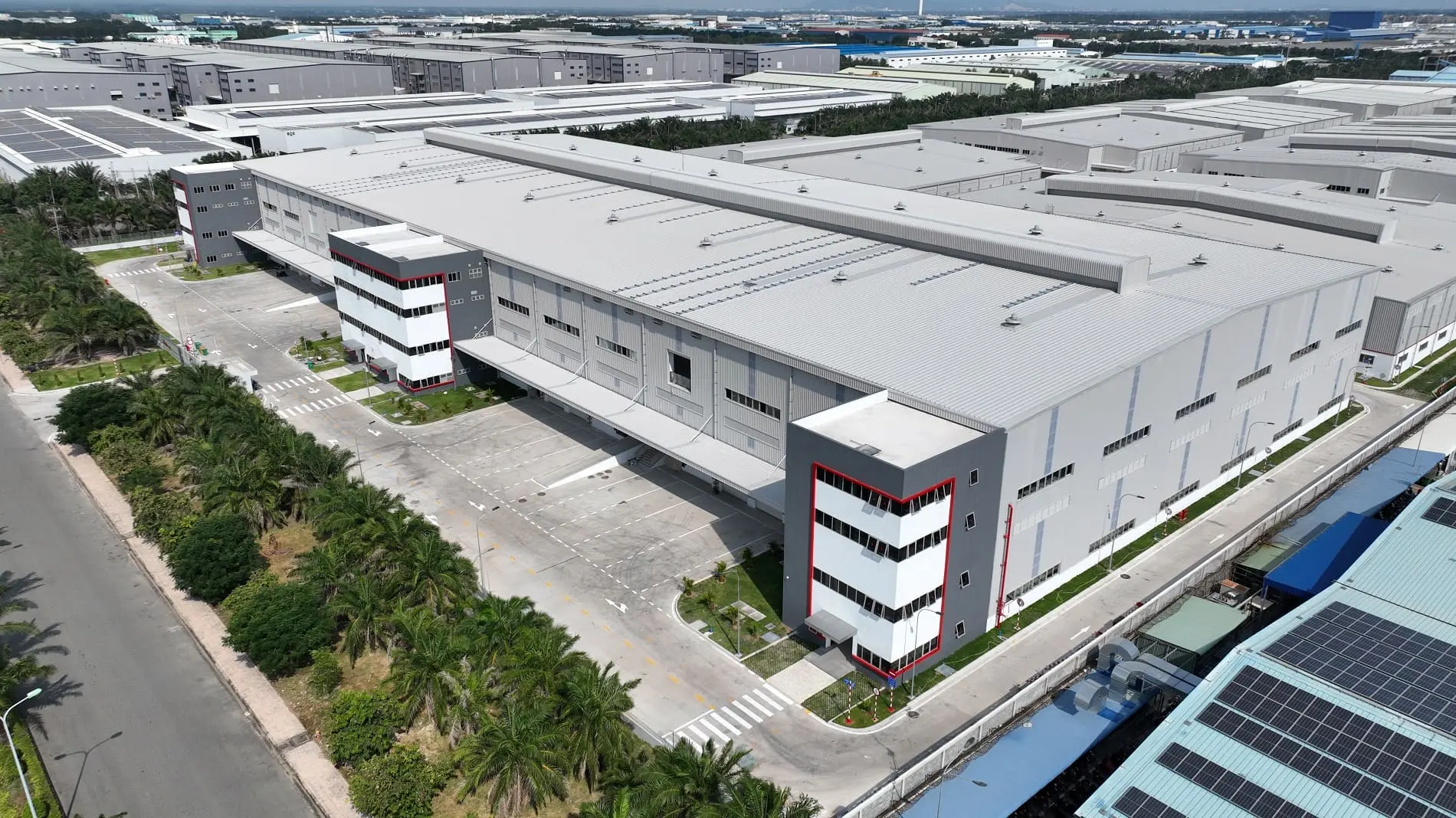 a large building with trees and a road